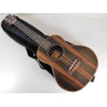 A Freshman walnut ukulele with case 26in long