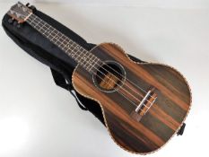 A Freshman walnut ukulele with case 26in long