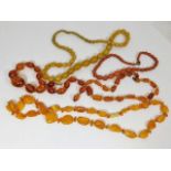 A selection of amber & other similar colour neckla