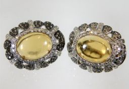 A pair of 18ct white gold earrings set with diamon