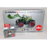 A boxed model Siku diecast radio controlled tracto