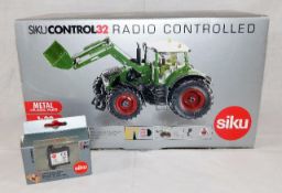 A boxed model Siku diecast radio controlled tracto