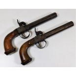 A pair of 18thC. percussion pistols with walnut st
