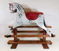 A child's dappled rocking horse 36in wide x 31in h
