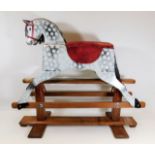 A child's dappled rocking horse 36in wide x 31in h