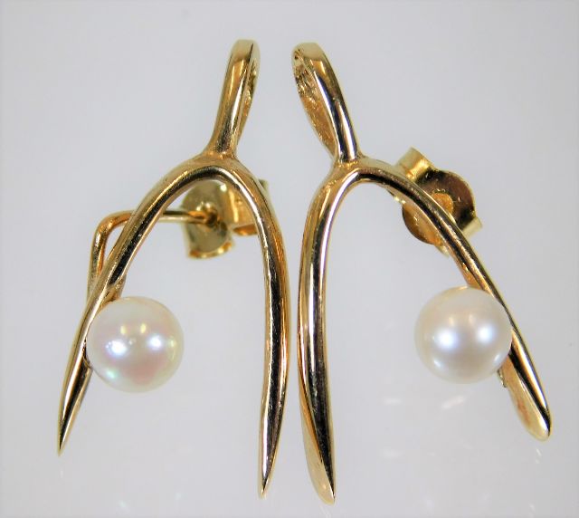 A pair of 9ct gold wishbone earrings set with pear