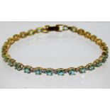 A 9ct gold bracelet set with diamonds & paraiba to