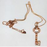 An 18ct pink gold chain & key pendant set with dia