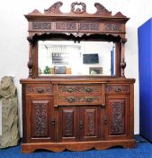 A Victorian mahogany dresser with ornately framed