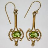 A pair of 9ct gold drop earrings set with peridot