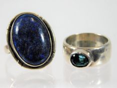 A white metal lapis lazuli ring twinned with one o