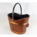 A coopered log bucket with copper handle