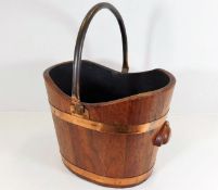 A coopered log bucket with copper handle