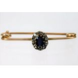 A yellow metal brooch set with sapphire & diamond