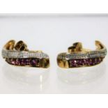 A pair of 9ct gold earrings set with diamond & rub