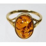 A 9ct gold ring with amber in fretwork setting 2.8