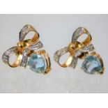 A pair of 14ct bow shaped diamond set earrings wit