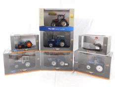 Seven boxed diecast tractor models including New H
