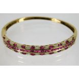 A 9ct gold bangle set with round & marquise cut ru