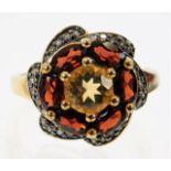 A 9ct gold ring set with citrine, garnet & small d