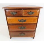 A small chest of drawers with a collection of shel