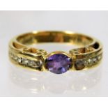 An 18ct gold ring set with amethyst with six diamo