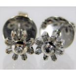 A pair of 9ct white gold diamond earrings set with