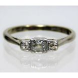 An 18ct gold ring set with three small diamonds 3.