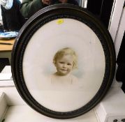 A oval framed portrait of child