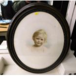 A oval framed portrait of child