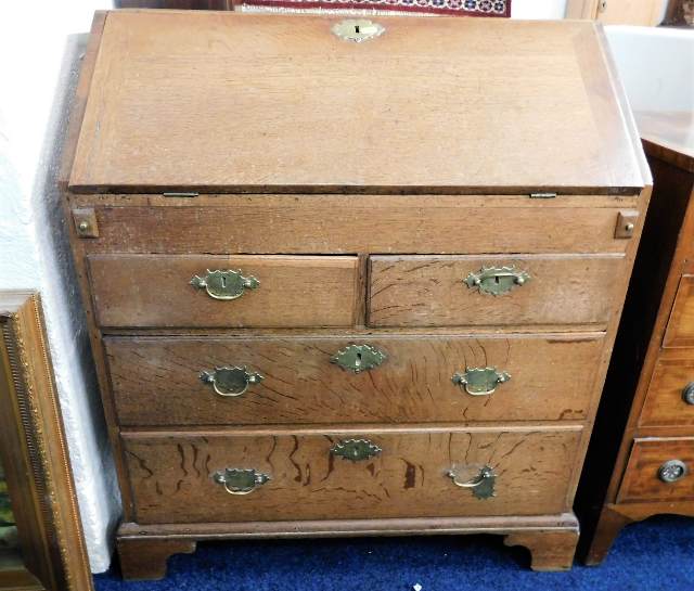 An 18thC. oak bureau with brass fittings 32 in wid