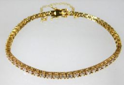 An 18ct gold tennis bracelet set with approx. 6ct