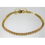 An 18ct gold tennis bracelet set with approx. 6ct