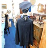 A vintage police overcoat twinned with later hat &