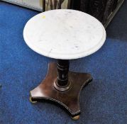 A low level marble topped pedestal table