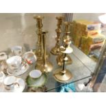 An 18thC. candlestick & four other brass candlesti