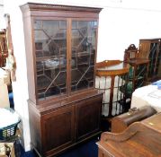 A c.1900 mahogany bookcase with cupboard under