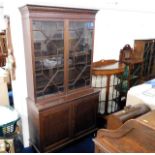 A c.1900 mahogany bookcase with cupboard under