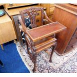 A mahogany childs high chair with carved decor