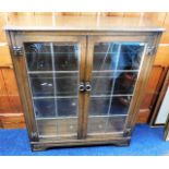 An oak glazed bookcase 43.5in high x 36.5in wide