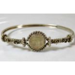 A white metal bracelet with carved moonstone "moon