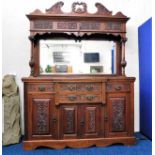 A Victorian mahogany dresser with ornately framed