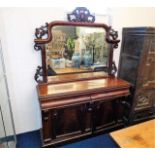 A decorative mahogany chiffonier with mirror over