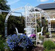 A decorative arbour with a garden table with four