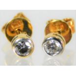 A pair of yellow metal diamond earrings with gold