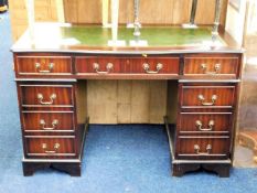 A 20thC. pedestal desk with brass fittings