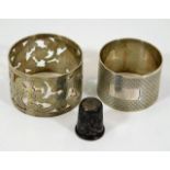 Two silver napkin rings twinned with a silver thim