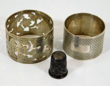 Two silver napkin rings twinned with a silver thim