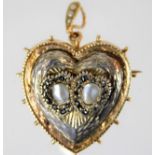 A two coloured yellow metal heart shaped pendant s