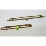 A 9ct gold brooch with peridot twinned with a yell